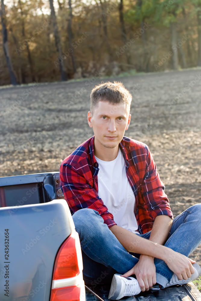 Fototapeta premium The man with offroad car in field
