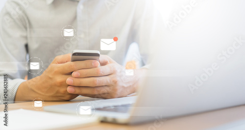 close up businessman holding smartphone and checking email online on web with virtual interface technology concept 