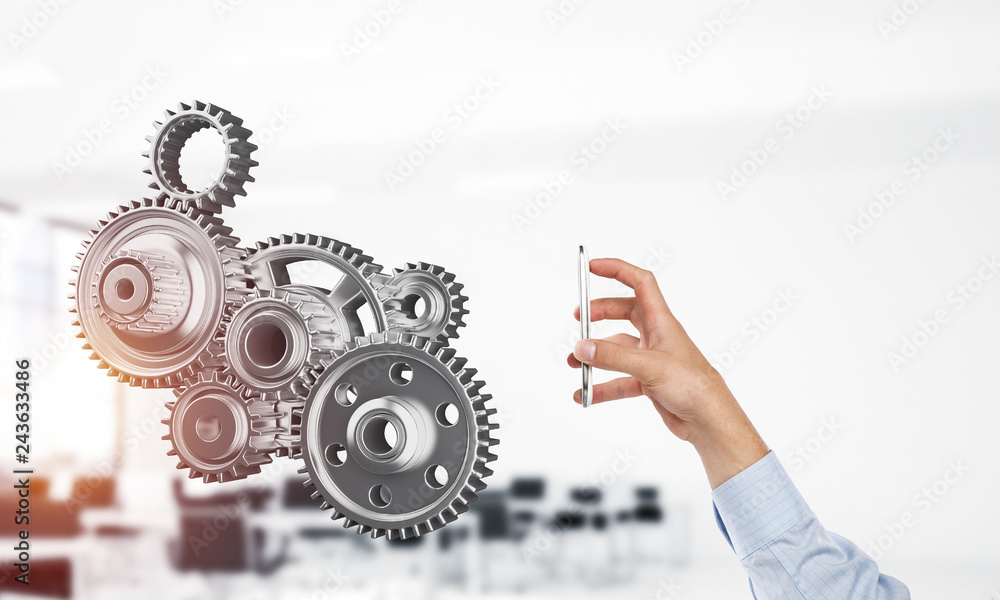 Engine mechanism in male hands as symbol for cooperation or team Engine mechanism in male hands as symbol for cooperation or team