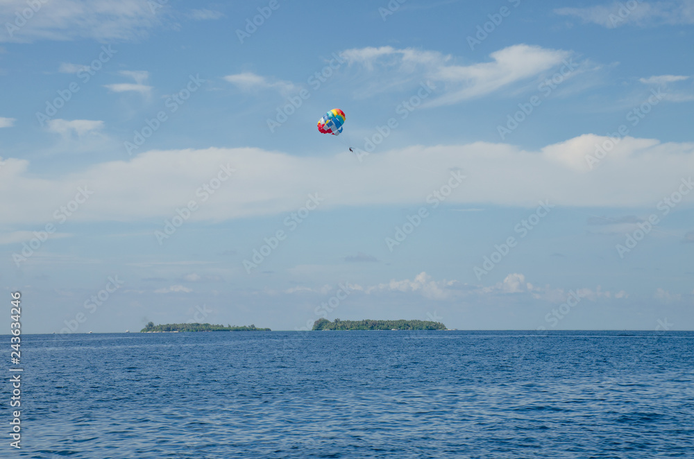 Parachute in the sky over Indian oceans the island of Maldives Parachute in the sky over Indian oceans the island of Maldives