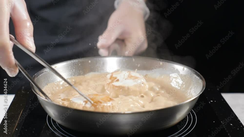 Cooking seafood. healthy food concept. Professional chef in gloves cooking scallops turning them with culnary pliers in slow motion. hd Cooking seafood. healthy food concept. Professional chef in gloves cooking scallops turning them with culnary pliers in slow motion. hd