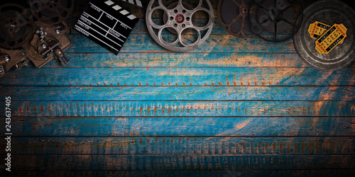 Cinema concept of vintage film reels, clapperboard and projector.