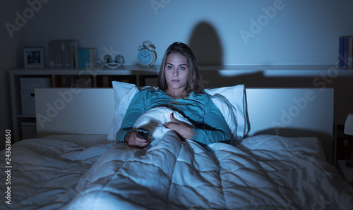Woman watching tv in bed