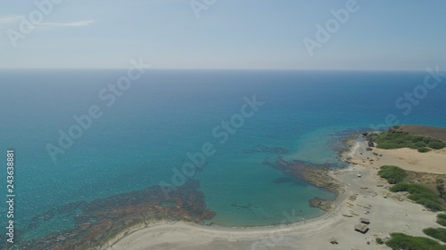Aerial view of beautiful beach, lagoons and coral reefs. Philippines, Luzon, Ilocos Norte. Coast ocean with turquoise water. Tropical landscape in Asia.
