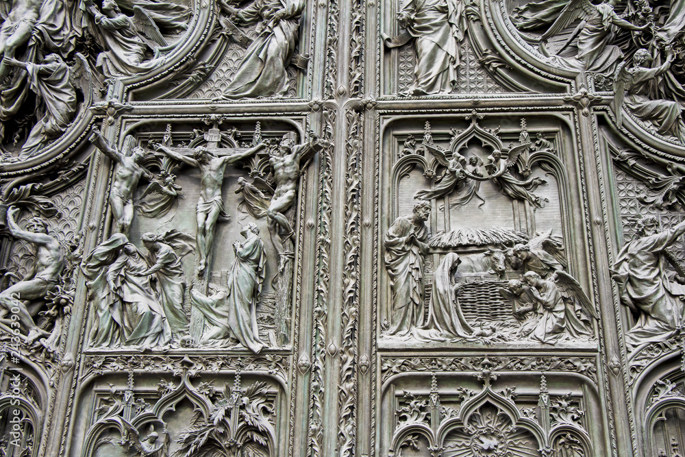 Detail bronze bas-reliefs of the Pieta scene in bas relief at Milan's Cathedral doors Detail bronze bas-reliefs of the Pieta scene in bas relief at Milan's Cathedral doors
