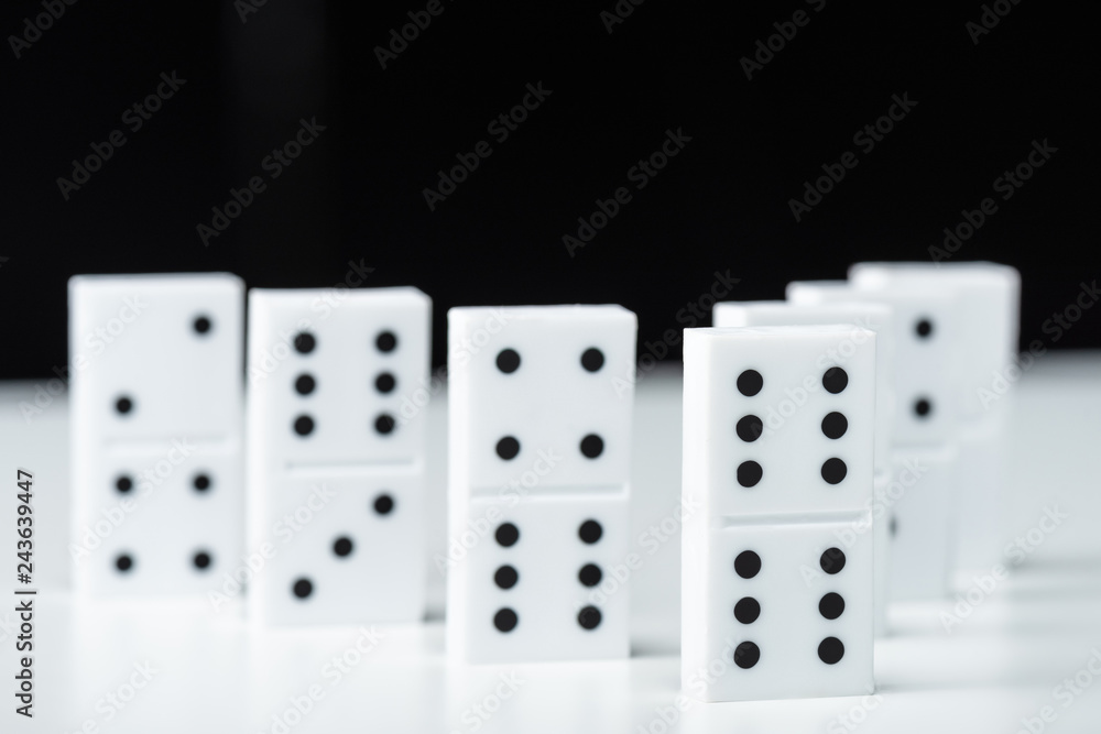 selective focus of domino row isolated on black selective focus of domino row isolated on black