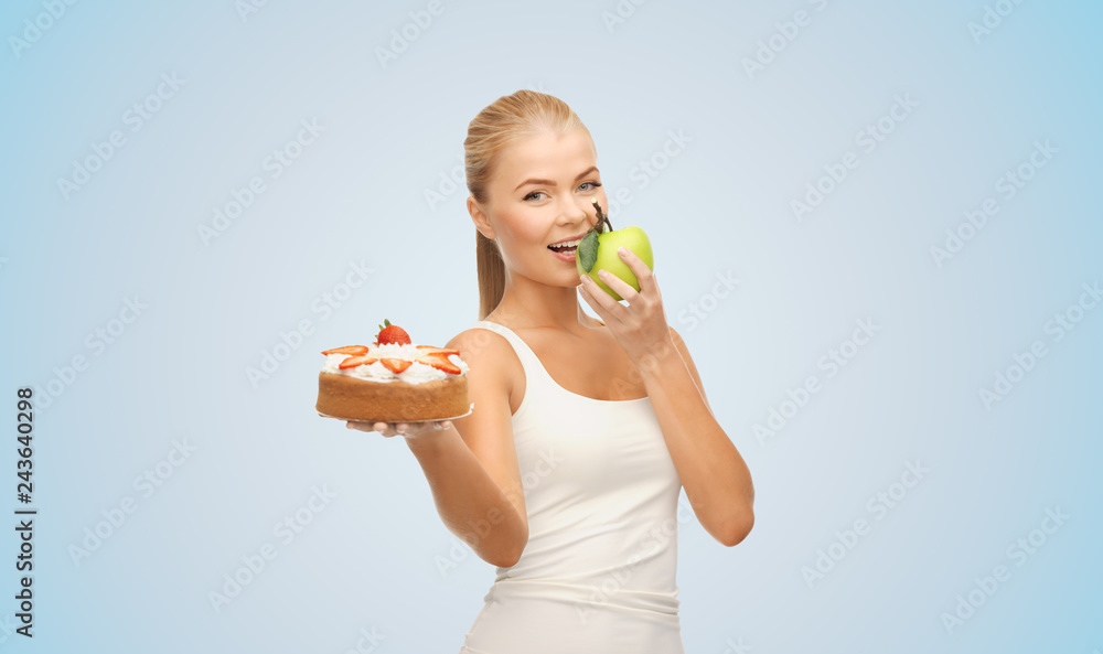 slimming and diet concept - happy woman eating apple instead of cake over blue background slimming and diet concept - happy woman eating apple instead of cake over blue background