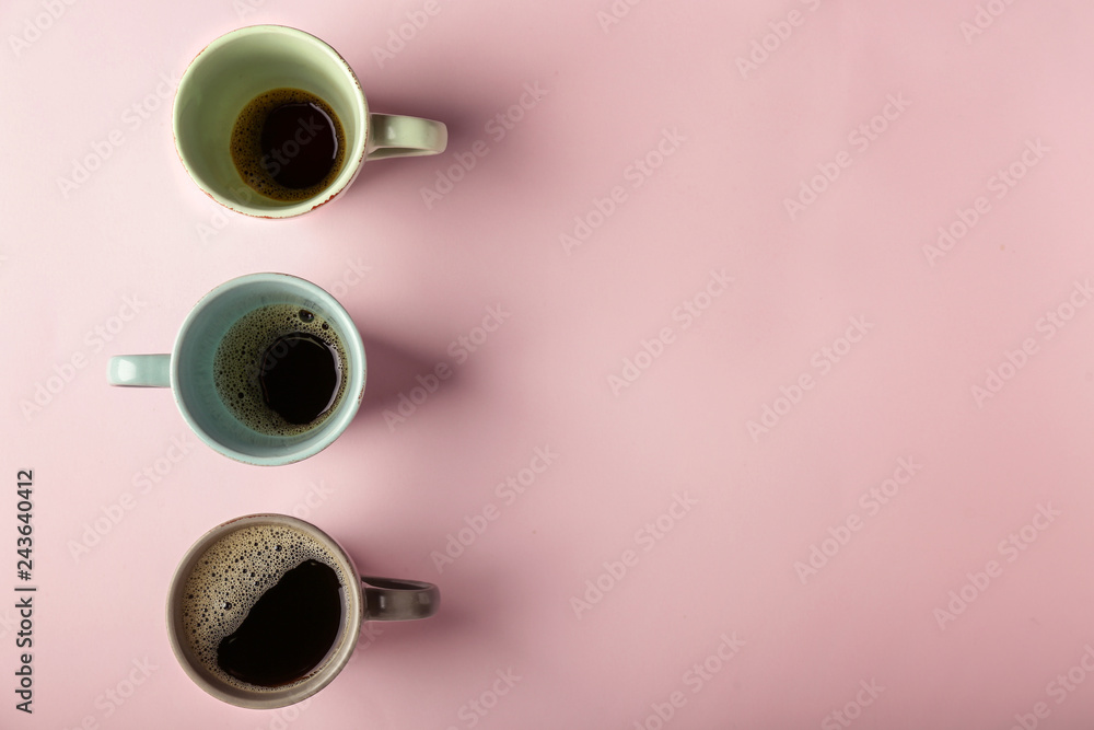 Cups of hot coffee on color background