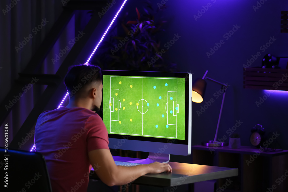 Young man playing computer game in club Young man playing computer game in club
