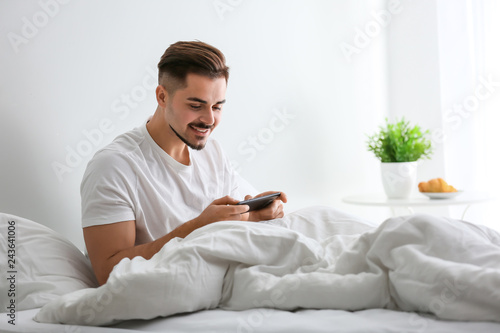 Young man playing game on s...