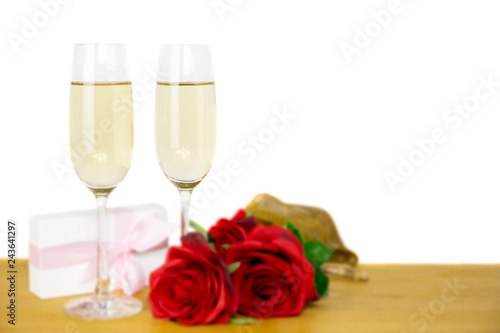 Glasses of champagne and rose flower with Valentines day gift box Isolated.
