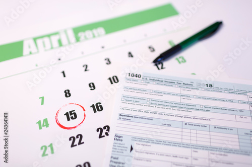 2019 calendar with 1040 income tax form for 2018 showing tax day for filing on April 15