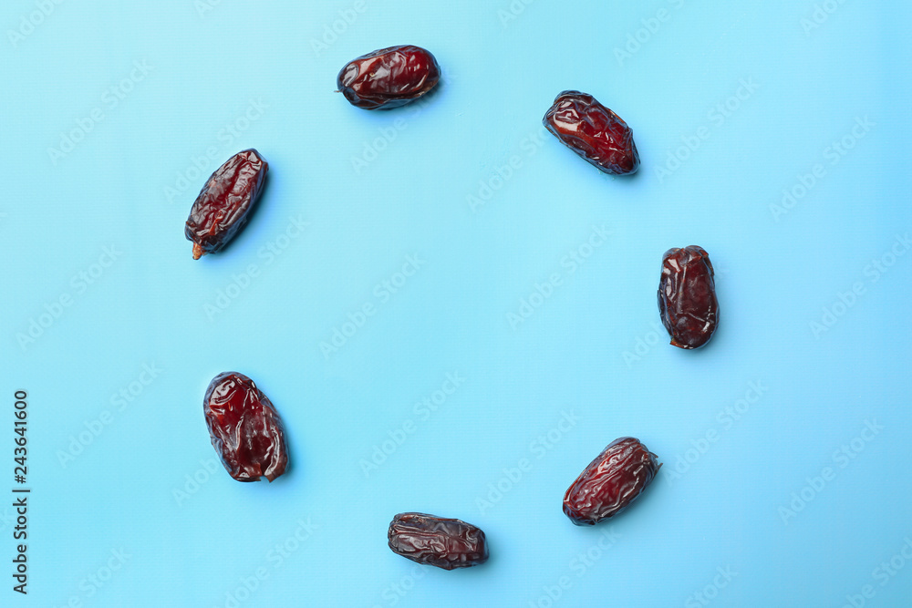 Circle made of sweet dried dates on color background Circle made of sweet dried dates on color background