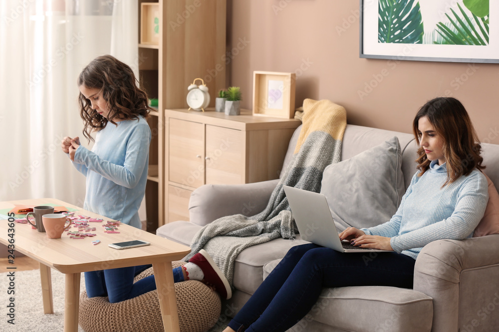 Busy mother with daughter working at home Busy mother with daughter working at home