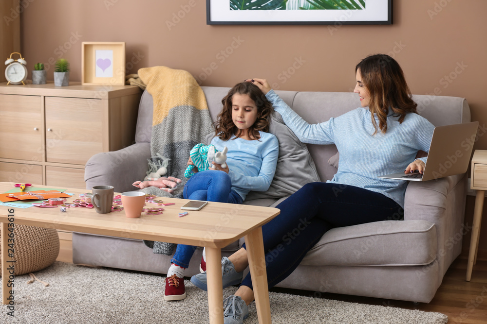 Busy mother with daughter working at home Busy mother with daughter working at home