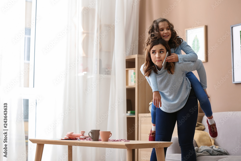 Busy mother with daughter at home Busy mother with daughter at home