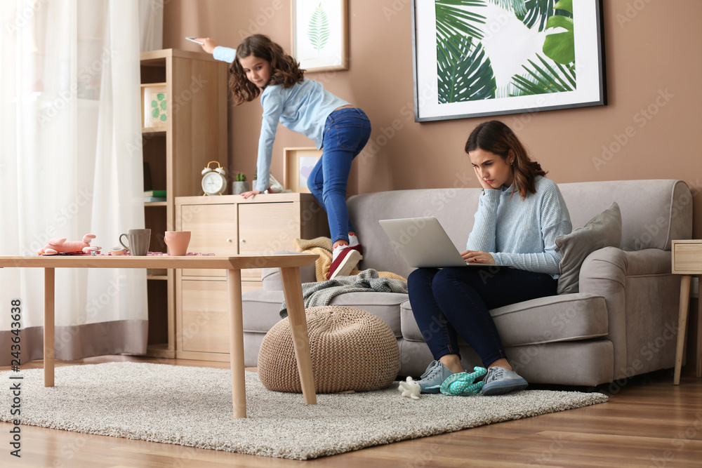 Busy mother with naughty daughter working at home Busy mother with naughty daughter working at home