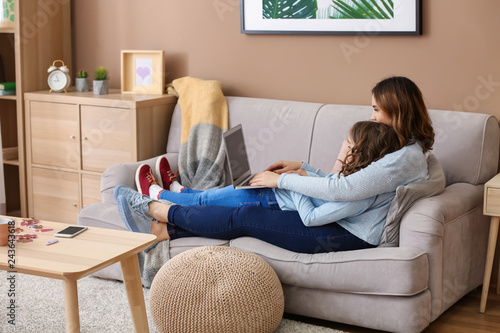 Busy mother with daughter working at home
