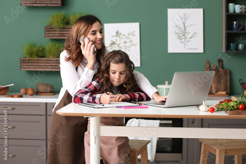 Busy mother with daughter w...