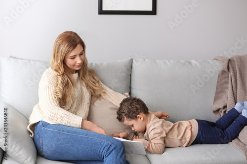 Young mother with cute litt...