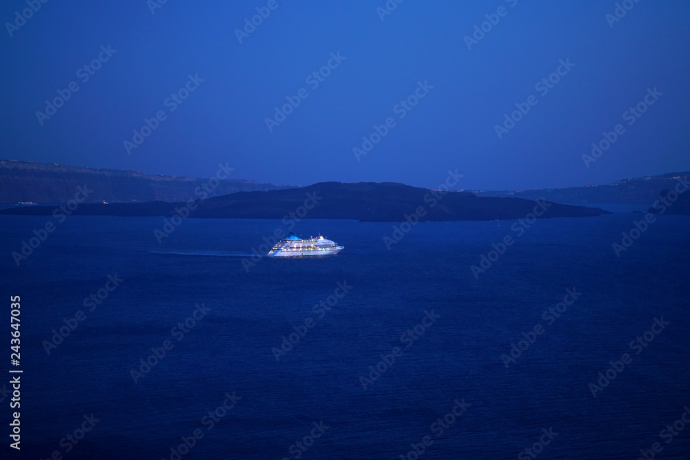 Colorful night view of a cruise ship in Oia, Santorini Colorful night view of a cruise ship in Oia, Santorini