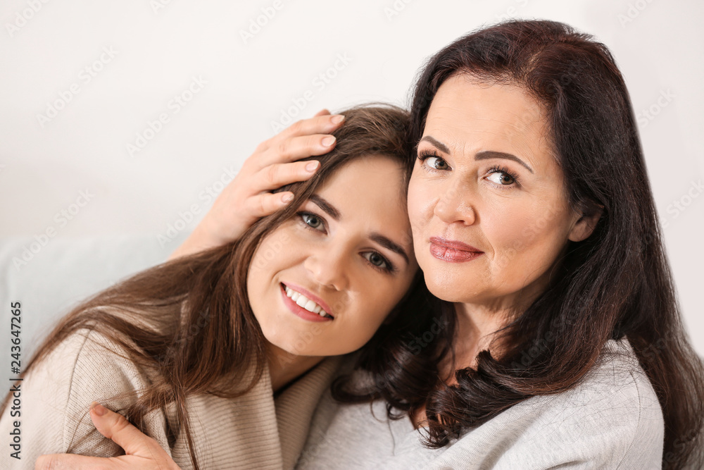 Portrait of young woman with her mother at home