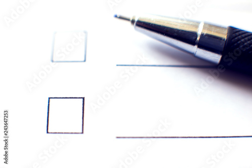 Checklist form with a pen on white paper. Checkbox concept.