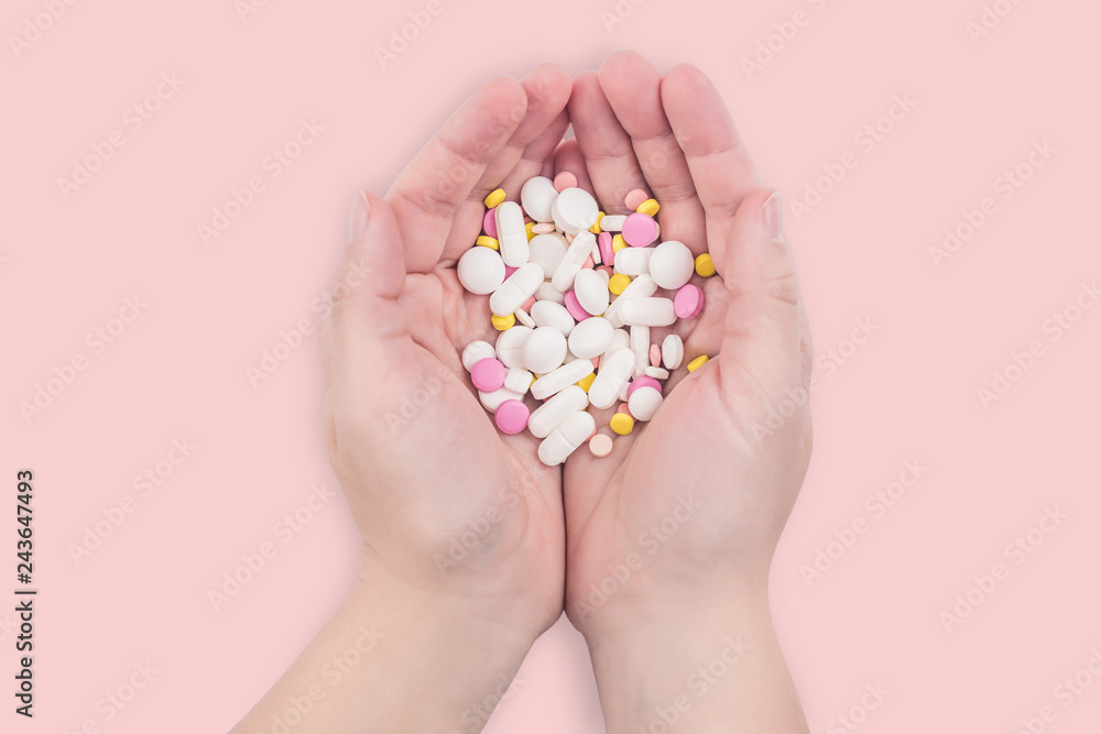 Female hands full of colorful medicines,pills, vitamins or supplements. The concept of a healthy and unhealthy lifestyle Female hands full of colorful medicines,pills, vitamins or supplements. The concept of a healthy and unhealthy lifestyle