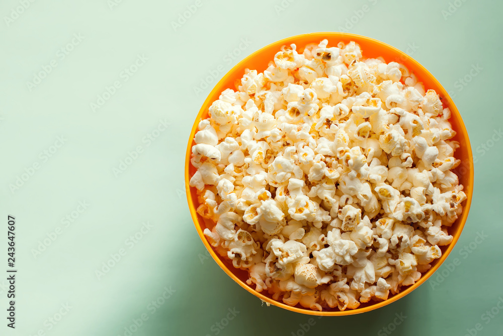 An orange bowl with popcorn isolated An orange bowl with popcorn isolated
