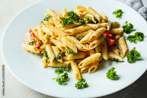 Tasty pasta with sauce and vegetables on plate, closeup