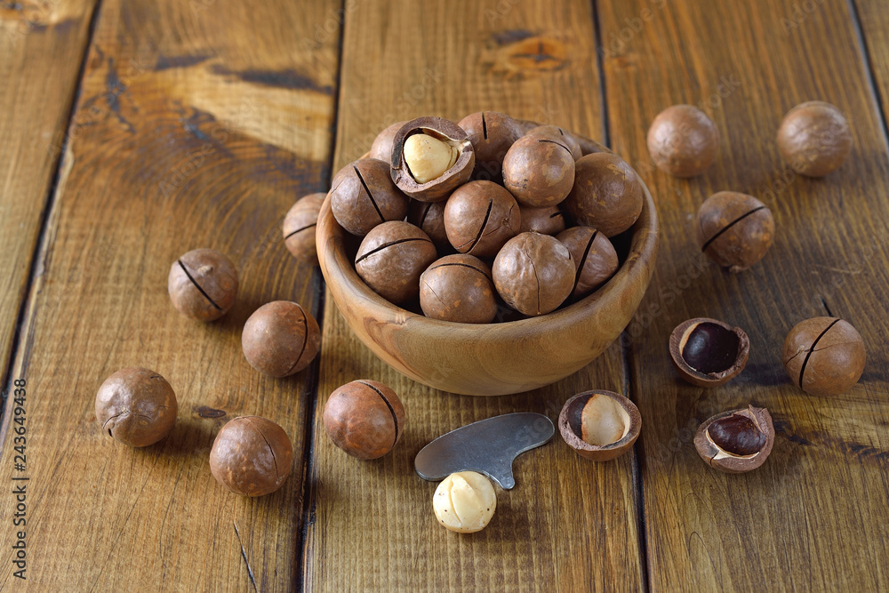 Macadamia nuts in a wooden bowl Macadamia nuts in a wooden bowl