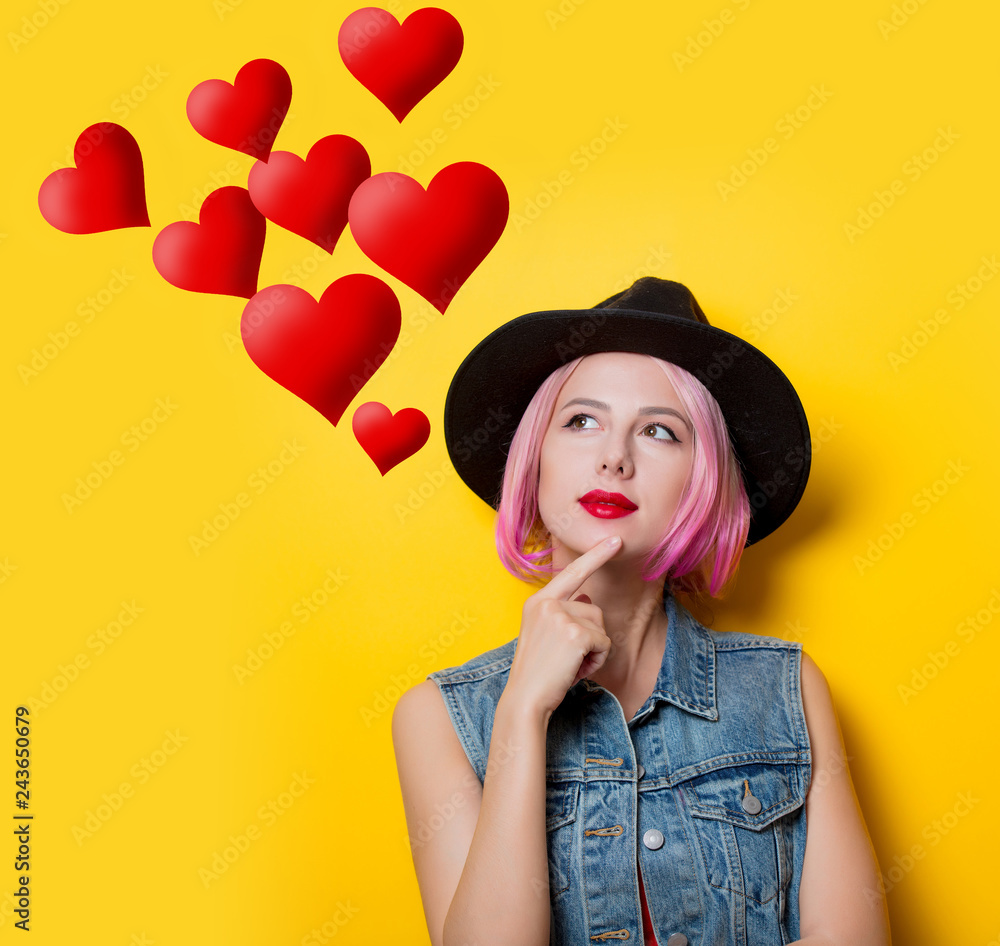 Portrait of young style hipster girl with pink hair style on yellow background Portrait of young style hipster girl with pink hair style on yellow background