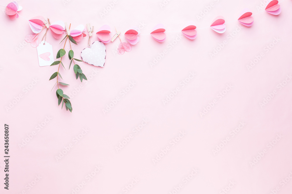 Colorful paper garland of hearts on the living coral background. Valentine day greeting cards.