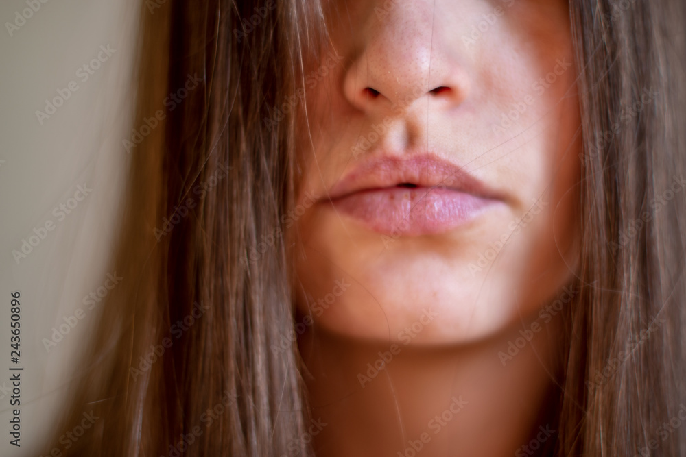 Beautiful girl grimacing in front of the mirror. Cosmetic procedures. Close-up. Selective focus, shallow depth of field. Beautiful girl grimacing in front of the mirror. Cosmetic procedures. Close-up. Selective focus, shallow depth of field.
