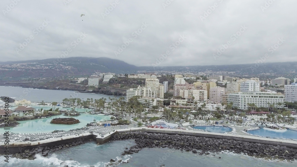 Puerto de la Cruz in Tenerife. Aerial view of city skyline and famous pools