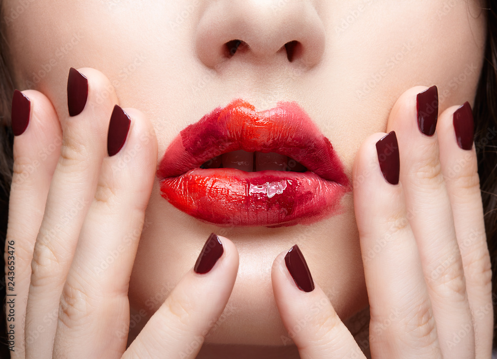 Naklejka premium Brunette girl with unusual alyapy red female face makeup