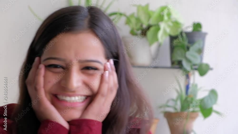 Attractive woman gets surprised and holds her face with both her hands in amusement and then eats her nails Attractive woman gets surprised and holds her face with both her hands in amusement and then eats her nails