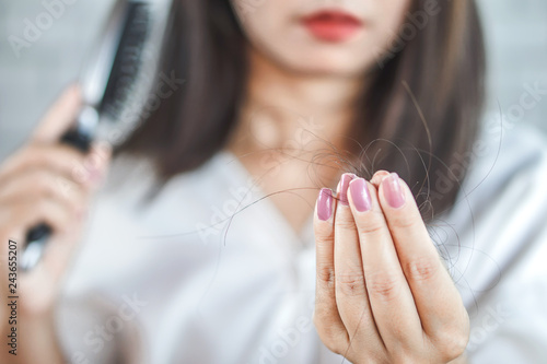 Photography closeup woman hand holding hair fall on comb
