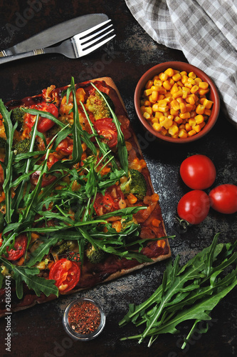 Eco food. Homemade vegan pizza with vegetables and fresh arugula. The concept of proper nutrition.