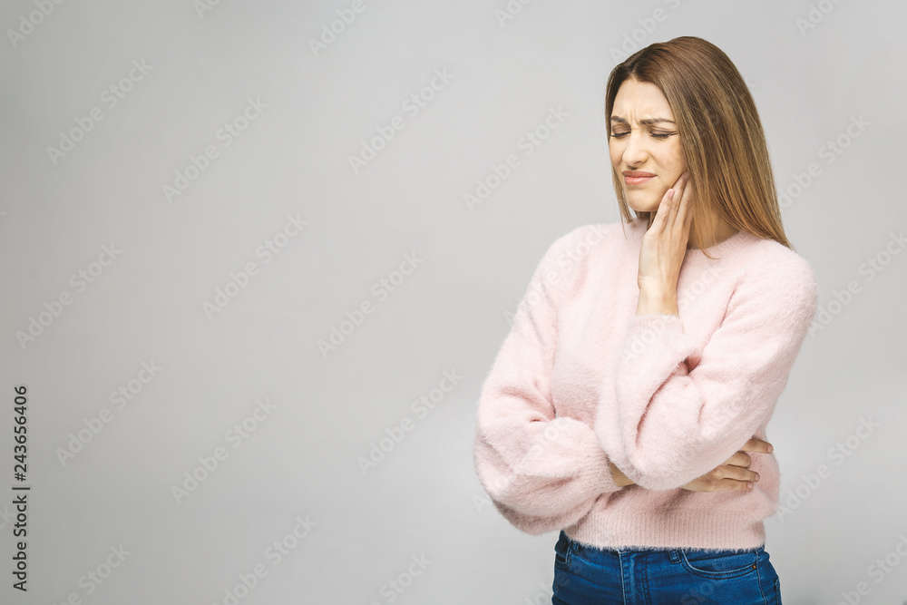 Beautiful young woman suffering from toothache on white background. Beautiful young woman suffering from toothache on white background.