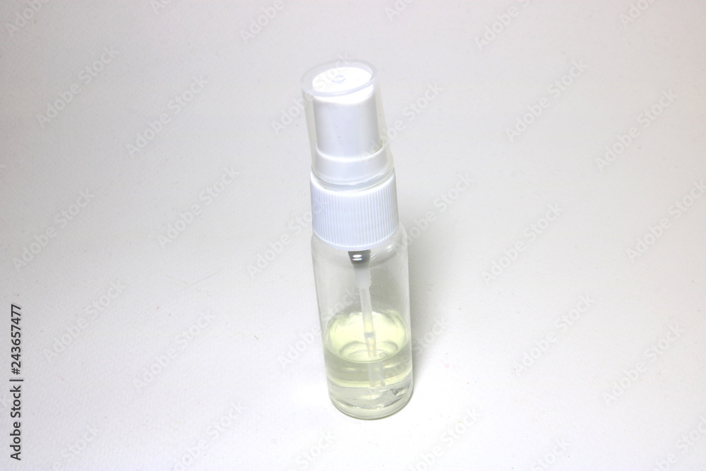 Small clear plastic spray bottle have caps are white and placed on a white background.