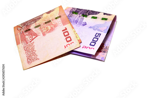 Thai banknotes in the amount of 100 baht and 500 baht. Fold overlapping on a white background.