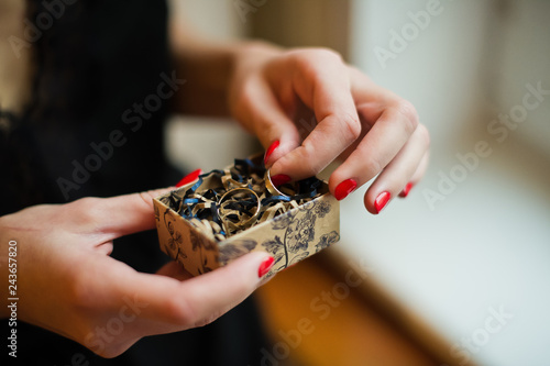 bride holding wedding rings, gold, close-up