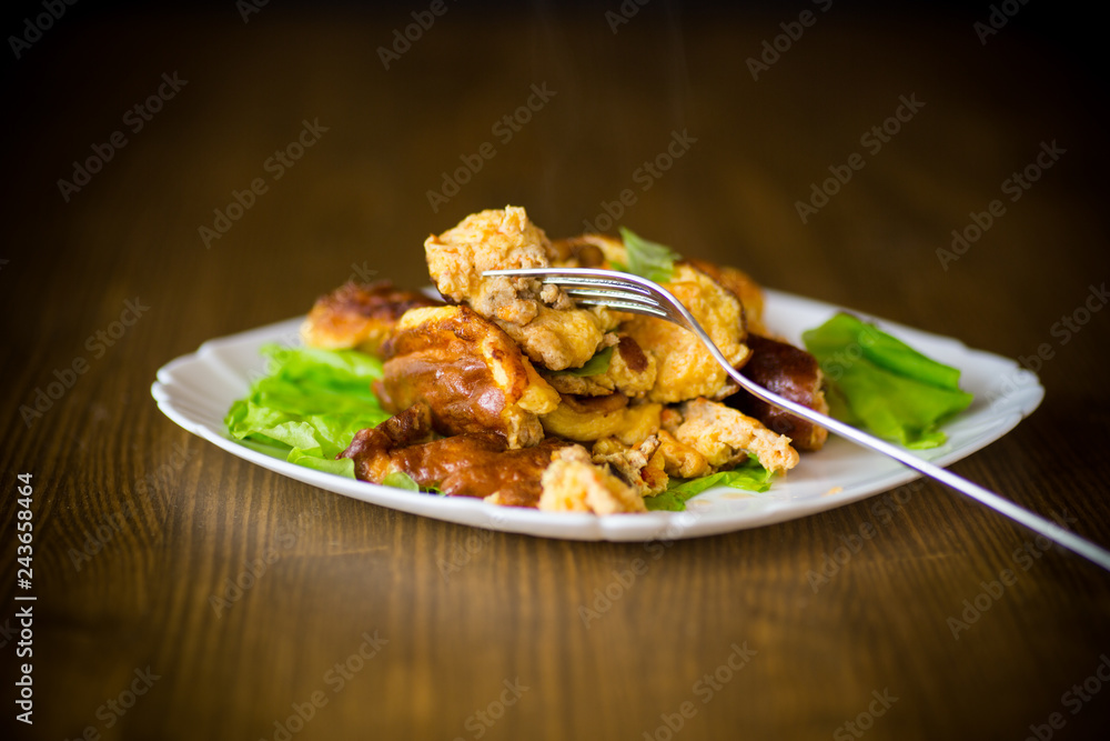 fried omelet with meat and greens in a plate fried omelet with meat and greens in a plate