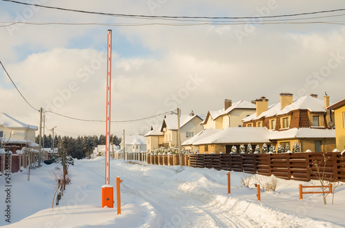 Barrier Gate Automatic system for security at the entrance to the cottage town. Winter sunny day