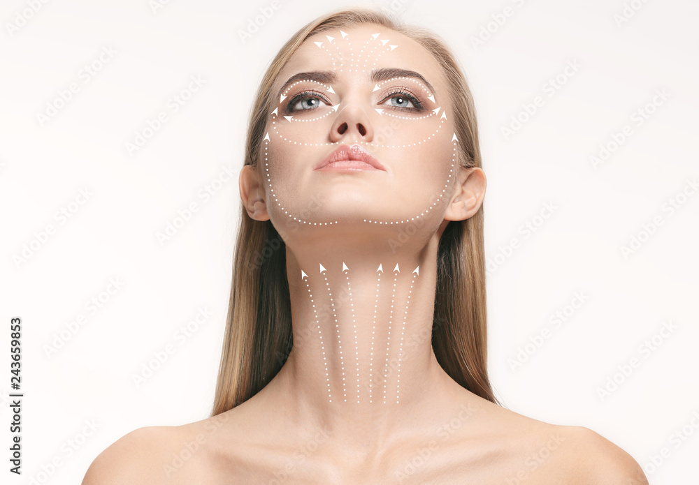 © master1305 - Close-up portrait of young, beautiful and healthy woman with arrows on her face. The spa, surgery, face lifting and skin care concept