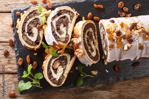Obraz na płótnie Christmas poppy seed cake partly sliced on wooden table