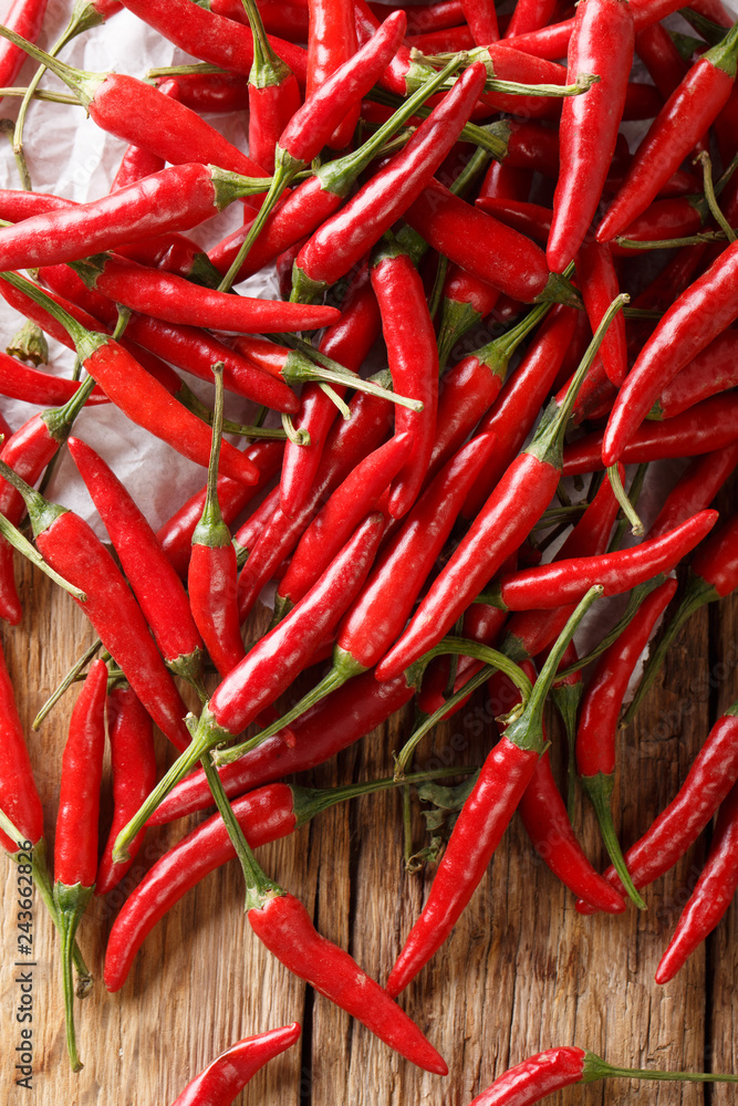 pile of fresh hot chili piri-piri pepper close-up on a table. Vertical top view