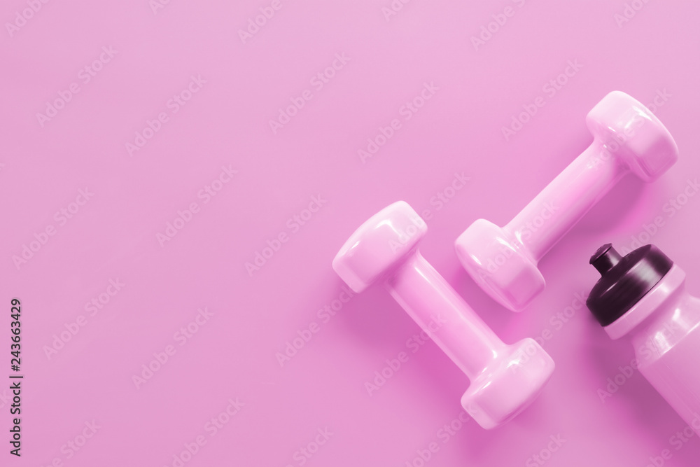 Fitness, Exercise, Working out healthy lifestyle Valentine's day background  concept. Pink dumbbells and pink bottle of water on pink background color.  Stock Photo