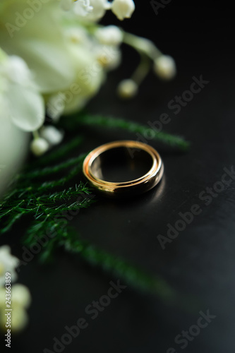 wedding rings on a dark background, Bridal bouquet, tulips